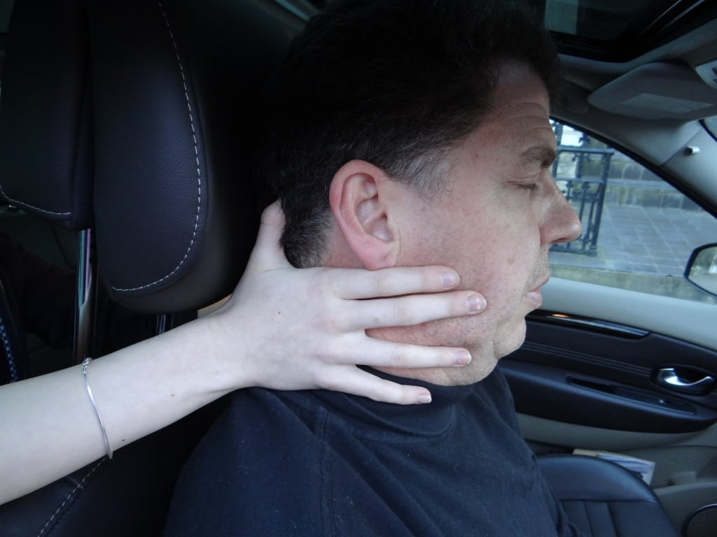 Supporting the head of an unconscious casualty in a car